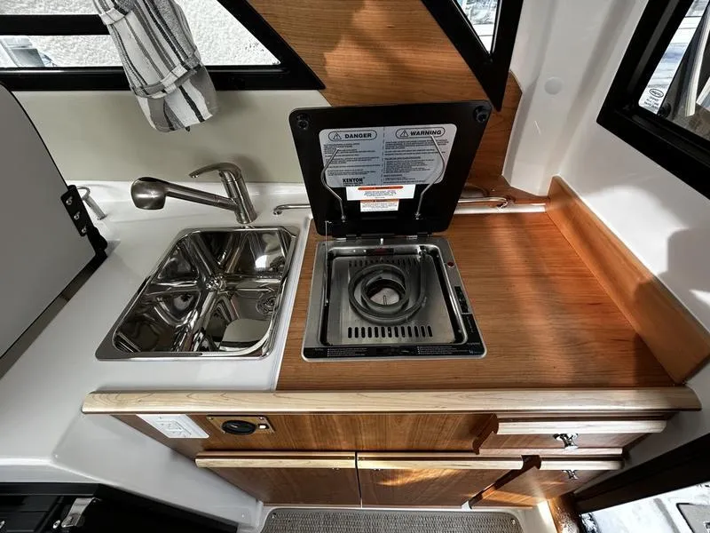 Slide: The Image of 2023 Cutwater C-248 C boat kitchen with sink and stove. - 14