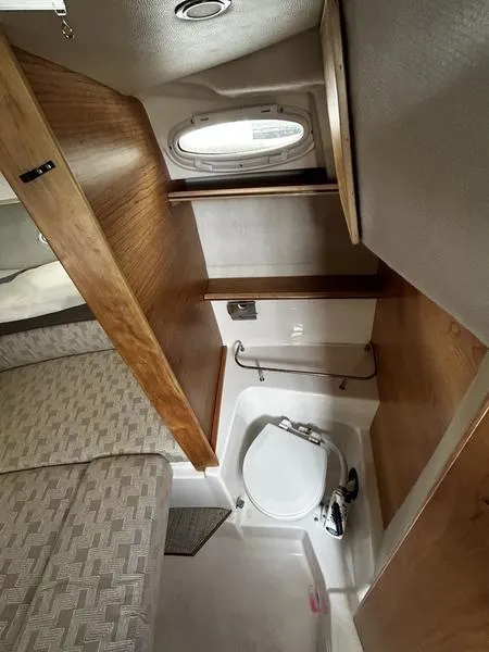 Slide: The Image of 2023 Cutwater C-248 C interior bathroom with wood accents and compact design. - 16