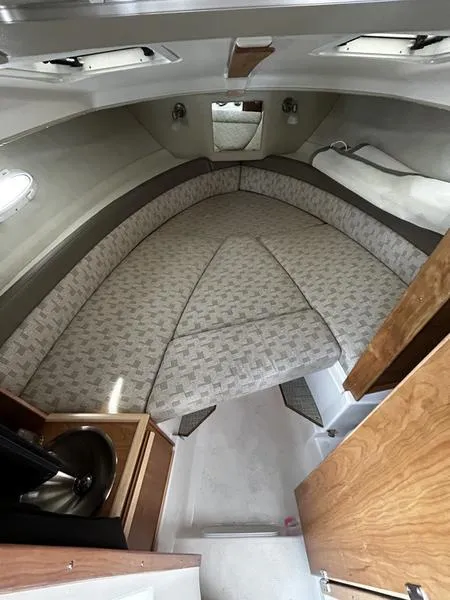 Slide: The Image of 2023 Cutwater C-248 C cabin interior with cushioned seating and compact sink area. - 17