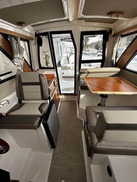 Slide: The Image of 2023 Cutwater C-248 C interior with seating and dining area, featuring modern design and wood accents. - 19