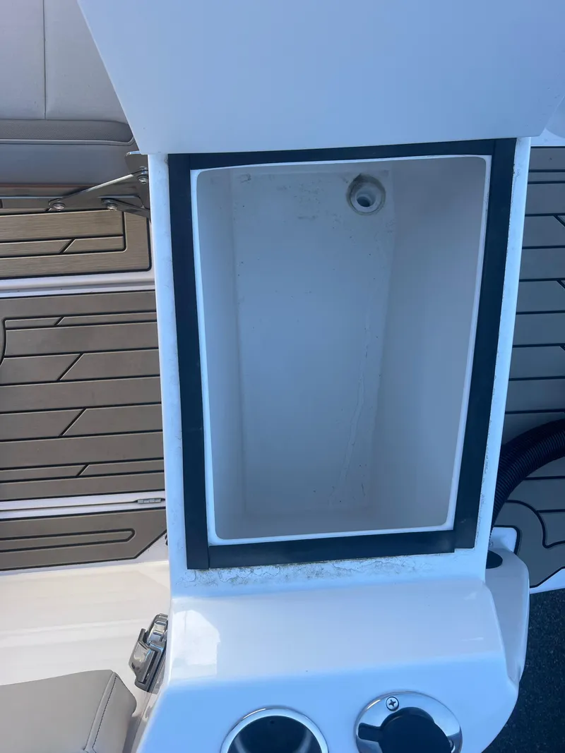 Slide: The Image of 2023 Cutwater C-248 C boat storage compartment with cup holders and seating area. - 23