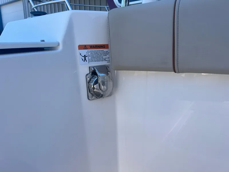 Slide: The Image of 2023 Cutwater C-248 C boat detail with warning label and chrome fixture. - 25
