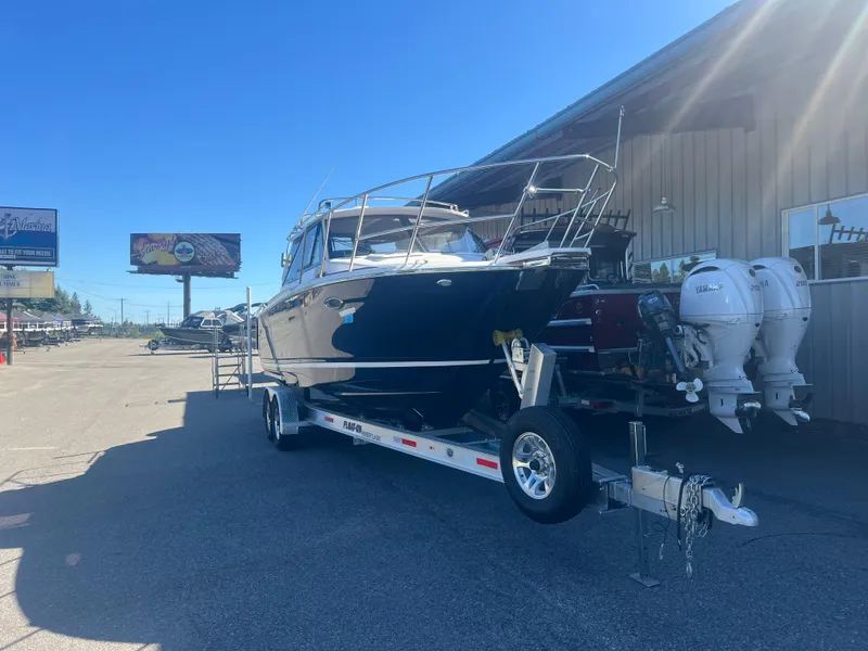Slide: The Image of 2023 Cutwater C-248 C boat on trailer, parked outside marina. - 3