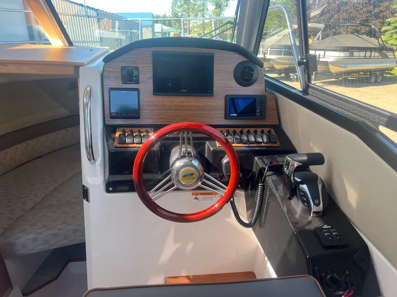 Slide: The Image of 2023 Cutwater C-248 C helm with red steering wheel and modern navigation controls. - 30