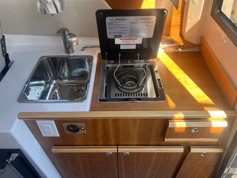Slide: The Image of 2023 Cutwater C-248 C boat kitchen with sink and stove. - 32