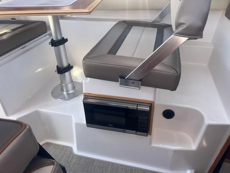 Slide: The Image of 2023 Cutwater C-248 C interior with seating and built-in microwave. - 34