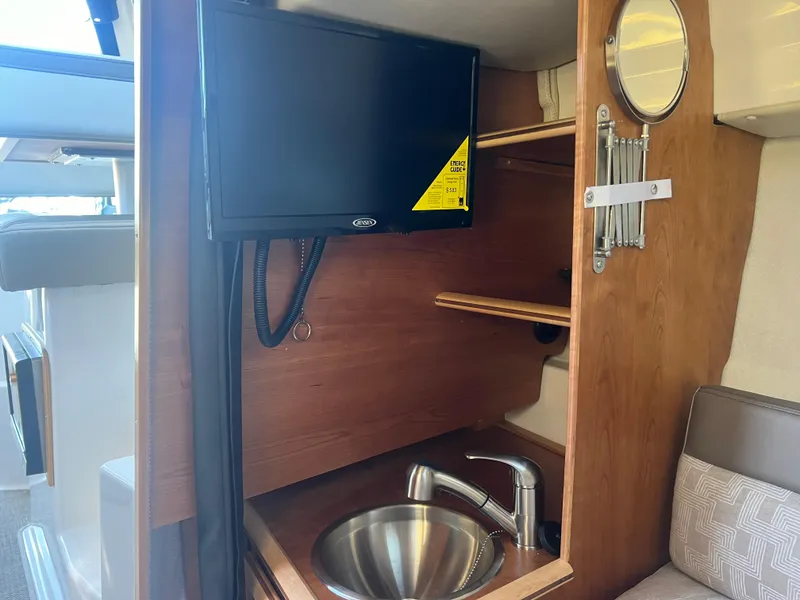 Slide: The Image of 2023 Cutwater C-248 C interior with TV, sink, and mirror. - 40