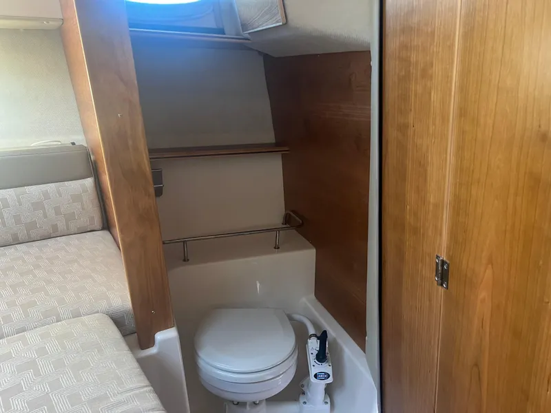 Slide: The Image of 2023 Cutwater C-248 C boat interior with compact bathroom and wooden accents. - 41