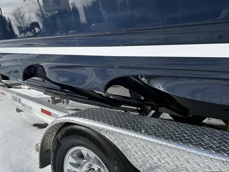 Slide: The Image of 2023 Cutwater C-248 C boat on trailer, close-up view of hull and wheel. - 7