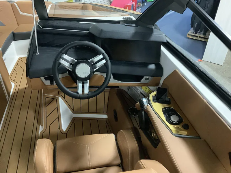 Slide: The Image of 2025 Nautique G23 boat interior with modern steering wheel and dashboard controls. - 10