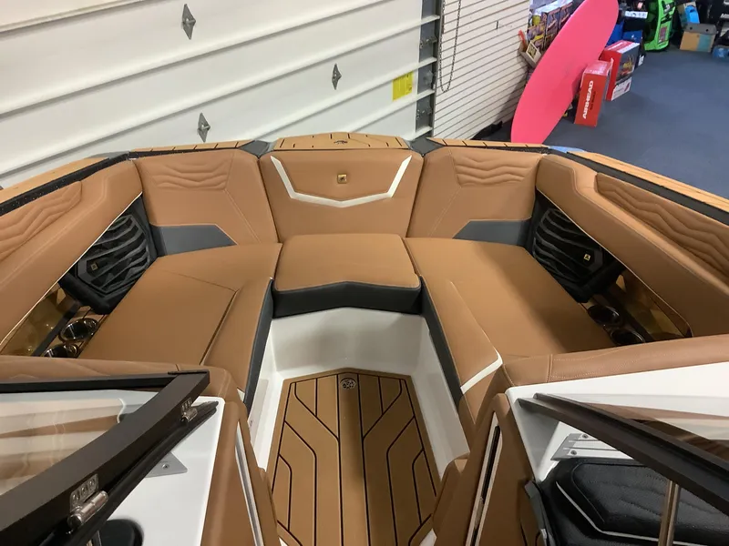Slide: The Image of 2025 Nautique G23 boat interior with tan leather seating and modern design. - 14