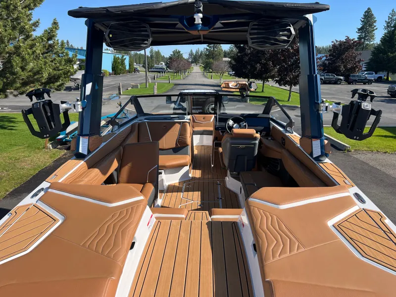 Slide: The Image of 2025 Nautique G23 boat interior with tan seating and sleek design. - 18