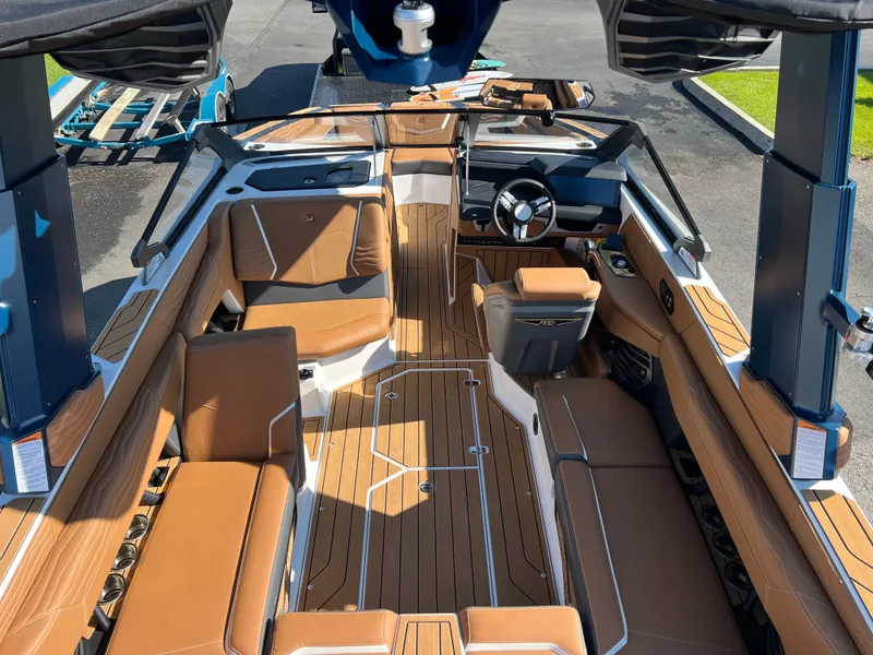 Slide: The Image of 2025 Nautique G23 boat interior with tan seating and sleek design. - 19
