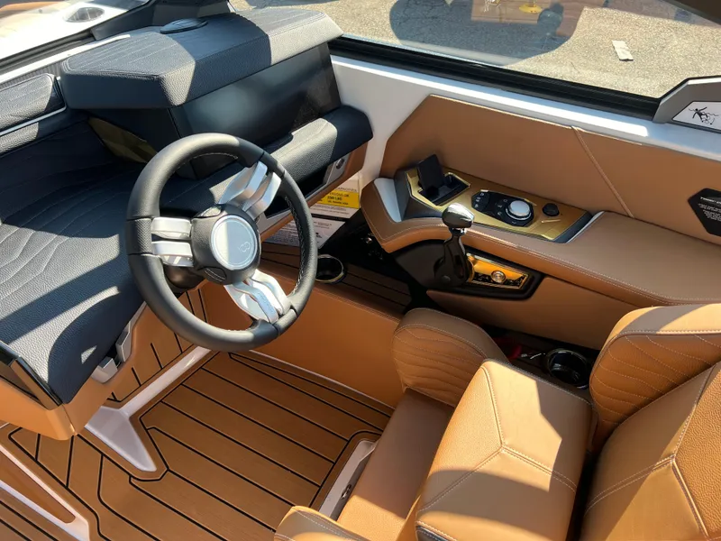 Slide: The Image of 2025 Nautique G23 boat interior with modern steering and controls. - 21