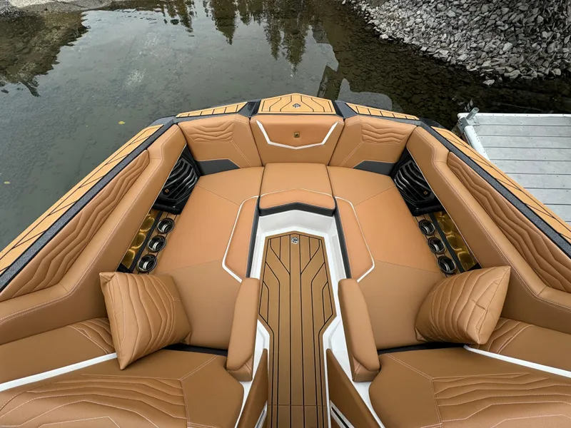Slide: The Image of Luxurious interior of 2025 Nautique G23 boat with tan upholstery and cup holders. - 3