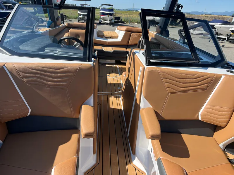 Slide: The Image of 2025 Nautique G23 boat interior with tan leather seats and modern design. - 31