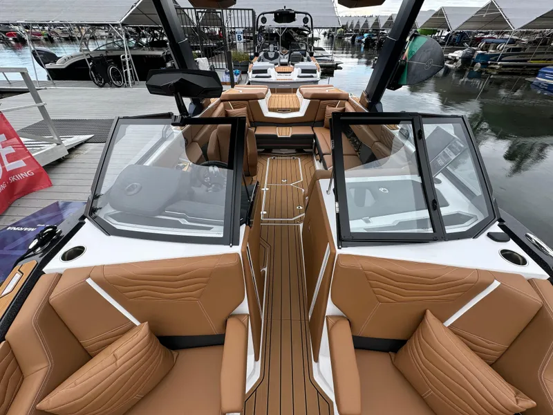 Slide: The Image of 2025 Nautique G23 boat interior with tan leather seating and sleek design. - 4
