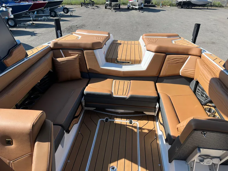 Slide: The Image of 2025 Nautique G23 boat interior with tan leather seating and teak flooring. - 41
