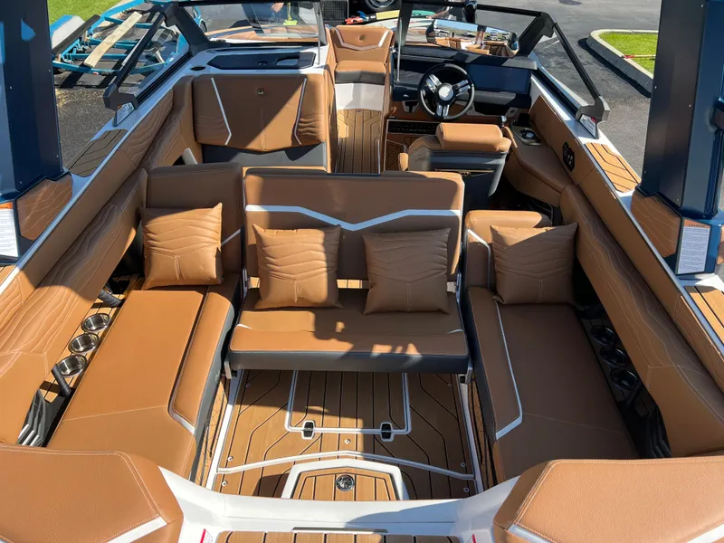 Slide: The Image of 2025 Nautique G23 boat interior with luxurious brown seating and modern design. - 43