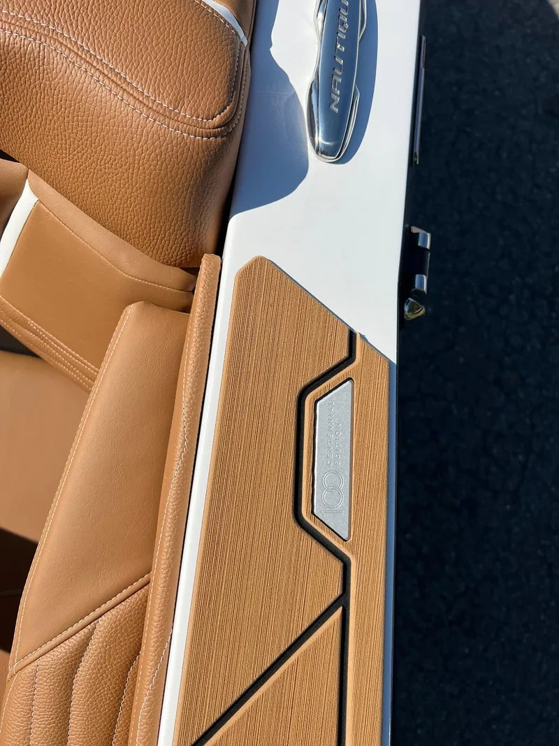 Slide: The Image of 2025 Nautique G23 boat interior with tan leather and sleek design details. - 47
