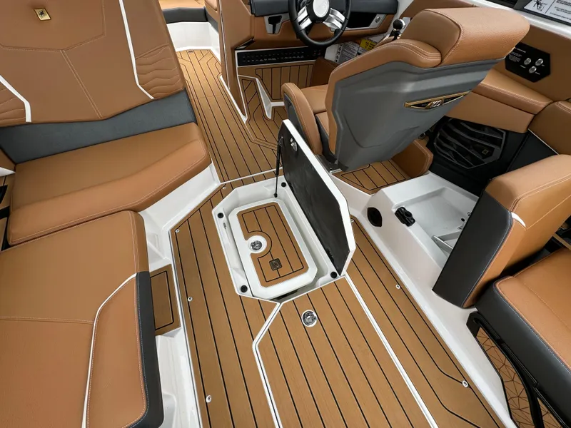 Slide: The Image of 2025 Nautique G23 interior with tan upholstery and sleek design. - 5