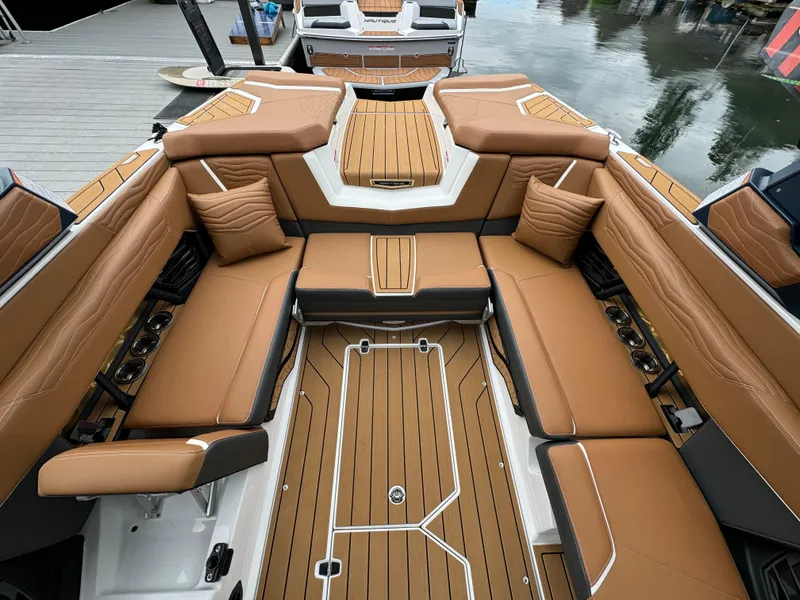 Slide: The Image of Luxurious interior of 2025 Nautique G23 boat with tan seating and wood accents. - 6