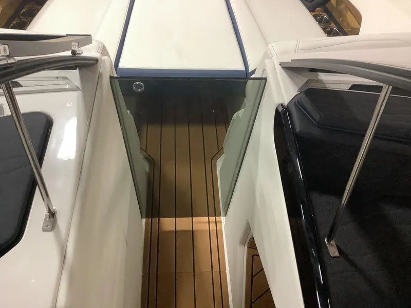 Slide: The Image of 2025 Nautique G25 boat interior with sleek seating and wooden flooring. - 11