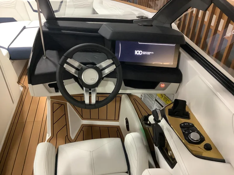 Slide: The Image of 2025 Nautique G25 boat cockpit with modern steering wheel and digital display. - 12