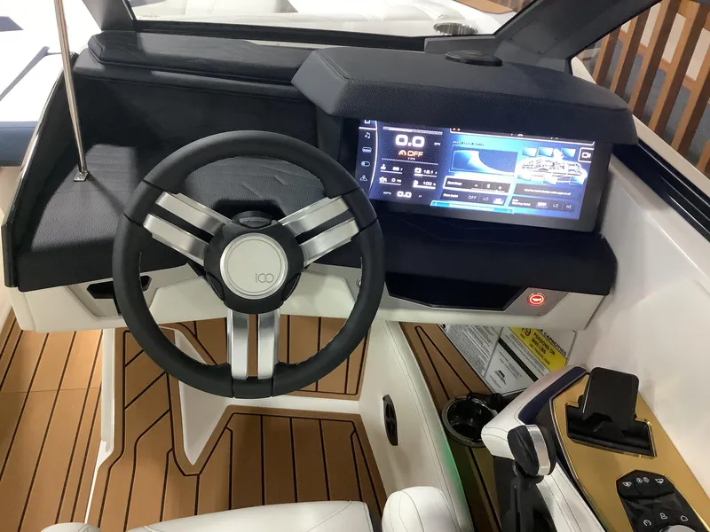 Slide: The Image of 2025 Nautique G25 boat dashboard with modern steering wheel and digital display. - 13