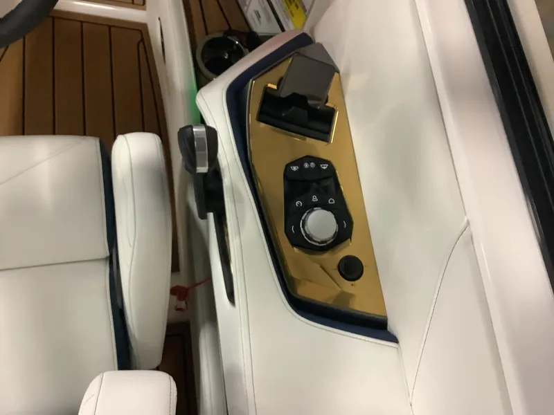 Slide: The Image of 2025 Nautique G25 boat interior control panel with luxurious design. - 14