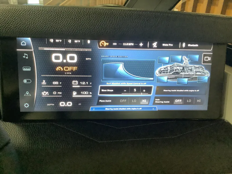 Slide: The Image of 2025 Nautique G25 dashboard display showing speed, wave shape, and steering settings. - 15