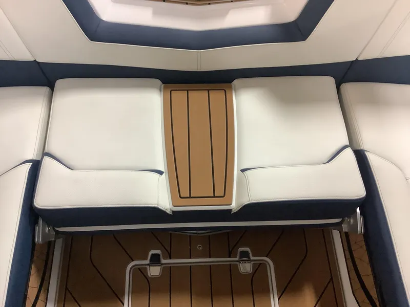 Slide: The Image of 2025 Nautique G25 boat interior with white and tan seating. - 20