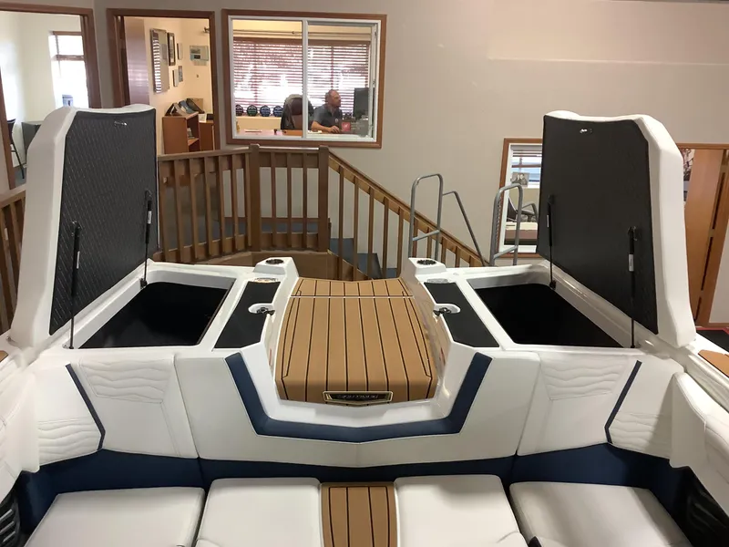 Slide: The Image of 2025 Nautique G25 boat interior with open storage compartments. - 23
