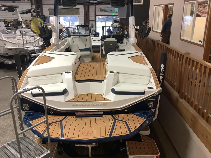 Slide: The Image of 2025 Nautique G25 boat with sleek design and spacious interior in showroom. - 3