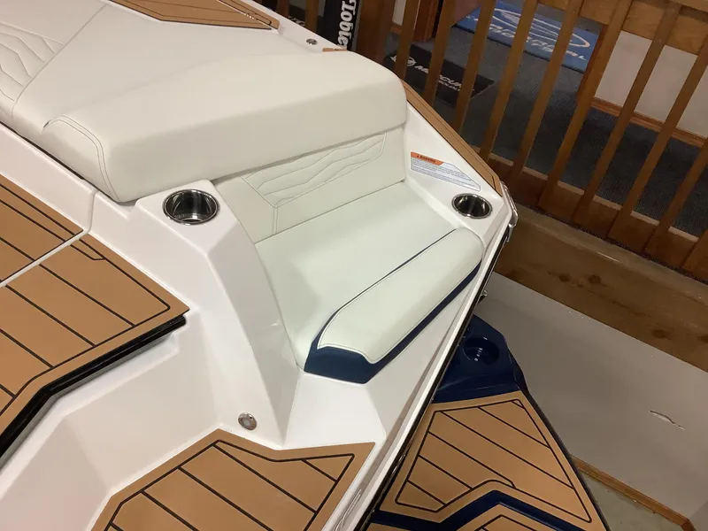 Slide: The Image of 2025 Nautique G25 boat interior with cushioned seating and cup holders. - 4