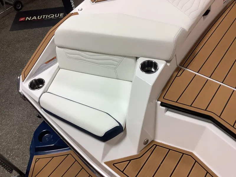 Slide: The Image of 2025 Nautique G25 boat interior with white seating and teak flooring. - 5