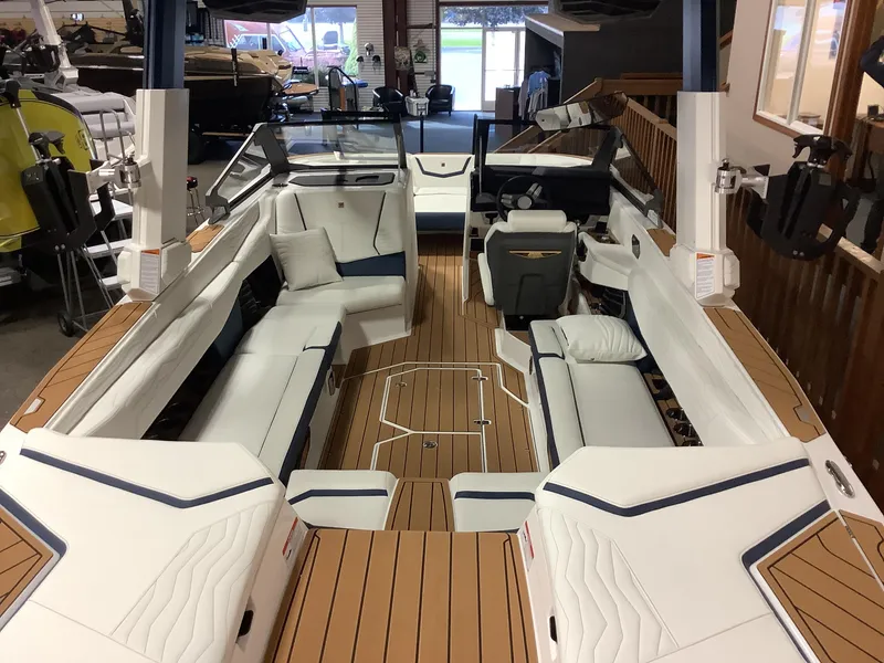 Slide: The Image of Luxurious interior of 2025 Nautique G25 boat with spacious seating and modern design. - 6