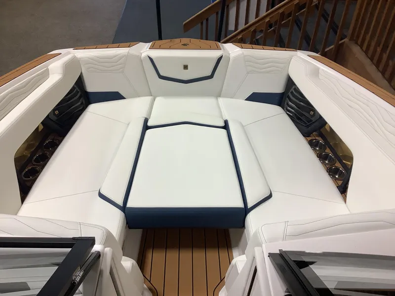 Slide: The Image of 2025 Nautique G25 boat interior with luxurious white seating and wood accents. - 7