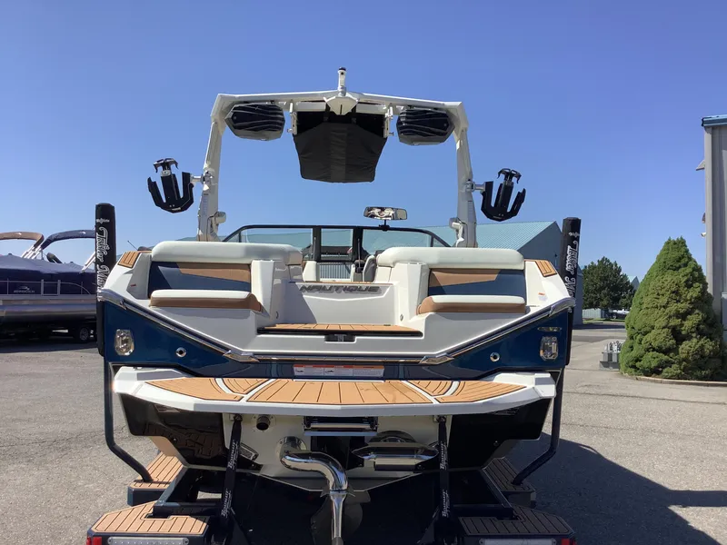 Slide: The Image of 2024 Nautique Super Air G23 boat, rear view, showcasing deck and seating. - 11