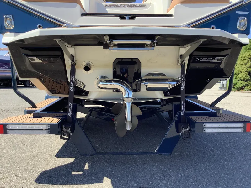 Slide: The Image of 2024 Nautique Super Air G23 boat rear view with propeller and swim platform. - 12