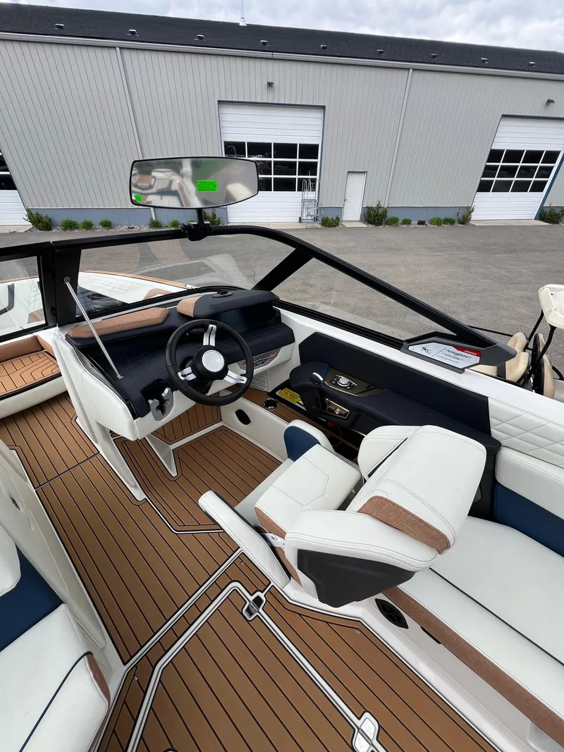 Slide: The Image of 2024 Nautique Super Air G23 boat interior with sleek design and modern dashboard. - 14