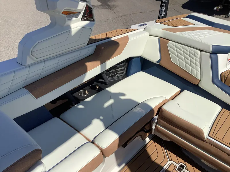 Slide: The Image of 2024 Nautique Super Air G23 interior with luxurious seating and cup holders. - 18