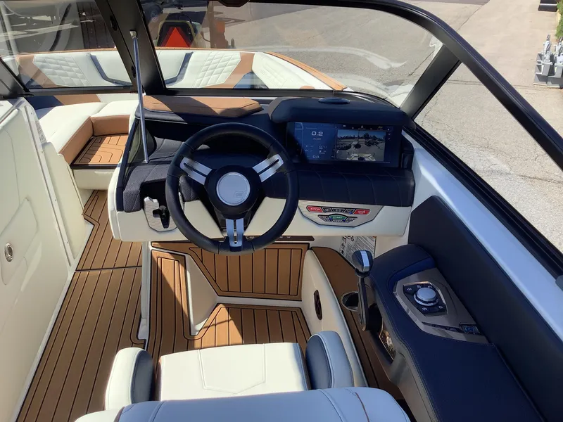 Slide: The Image of 2024 Nautique Super Air G23 boat interior with modern dashboard and steering wheel. - 21
