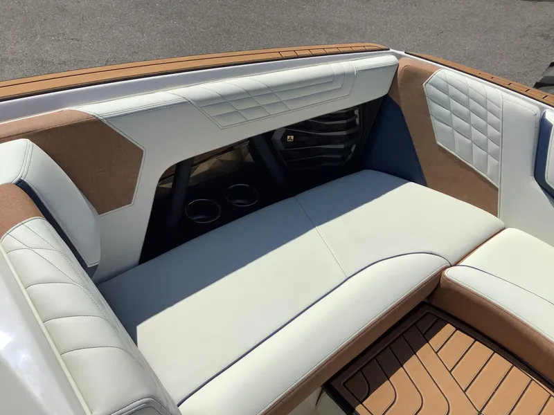 Slide: The Image of 2024 Nautique Super Air G23 interior seating with luxurious upholstery and cup holders. - 29