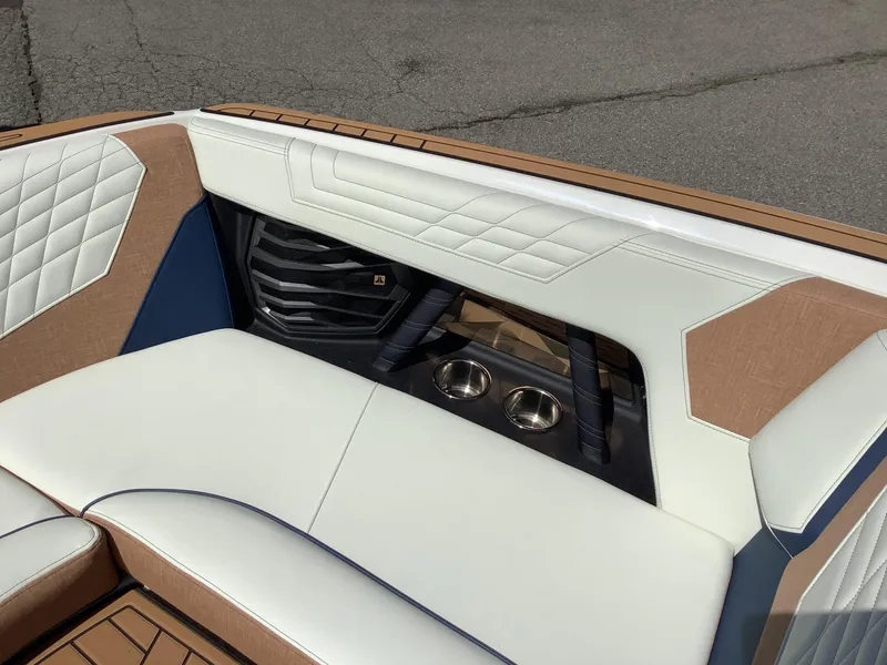 Slide: The Image of 2024 Nautique Super Air G23 interior with luxurious seating and cup holders. - 30