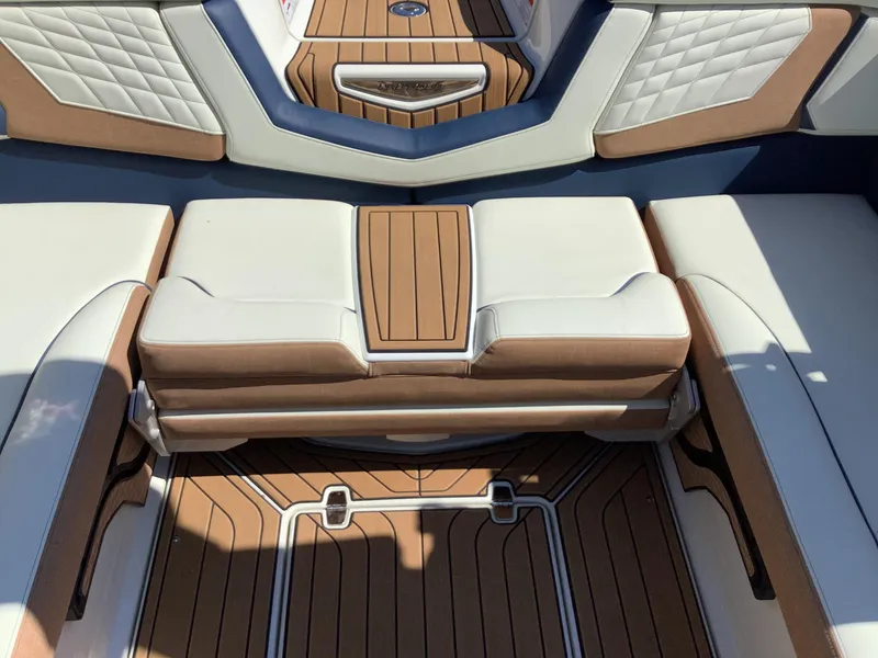 Slide: The Image of 2024 Nautique Super Air G23 interior with luxurious seating and teak flooring. - 31
