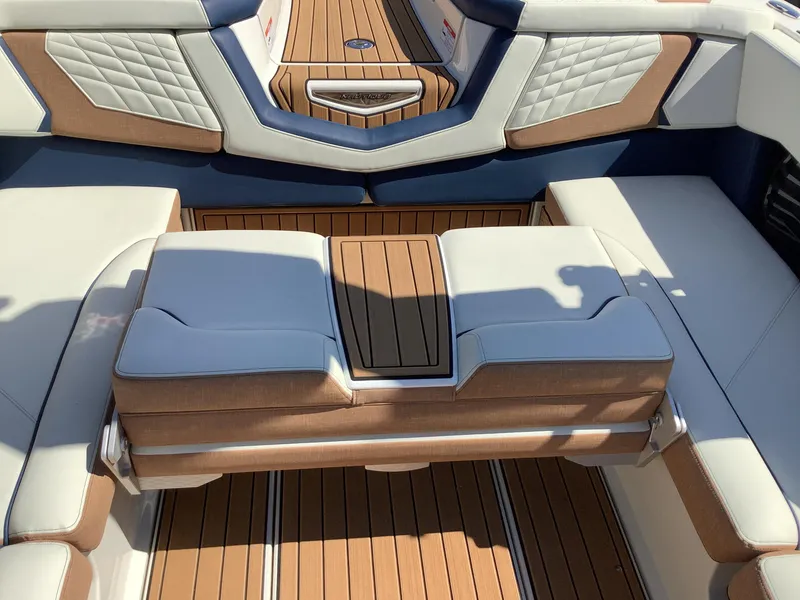 Slide: The Image of 2024 Nautique Super Air G23 interior with luxurious seating and teak flooring. - 32