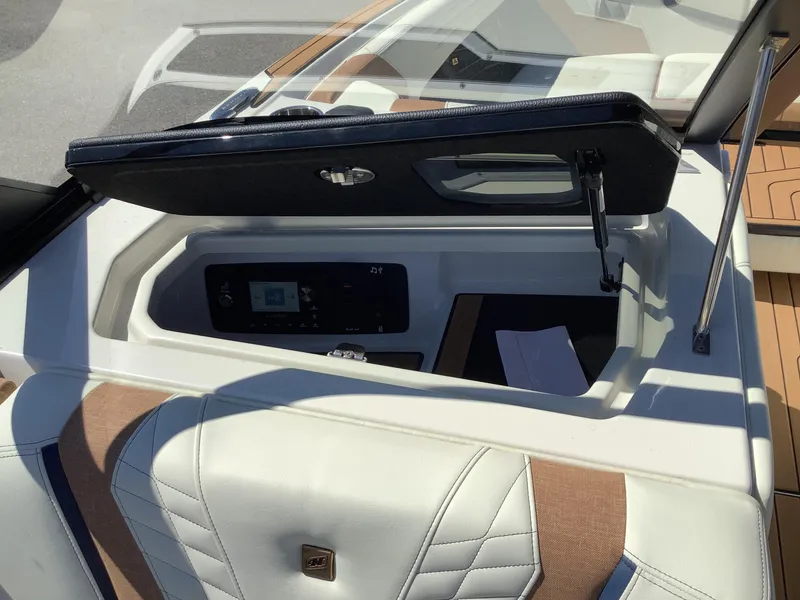 Slide: The Image of 2024 Nautique Super Air G23 boat interior with open storage compartment. - 35