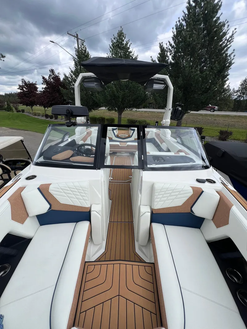 Slide: The Image of 2024 Nautique Super Air G23 boat interior with luxurious seating and sleek design. - 5
