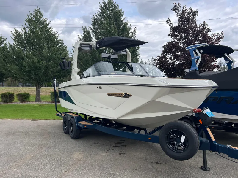 Slide: The Image of 2024 Nautique Super Air G23 boat on trailer, parked outdoors. - 6